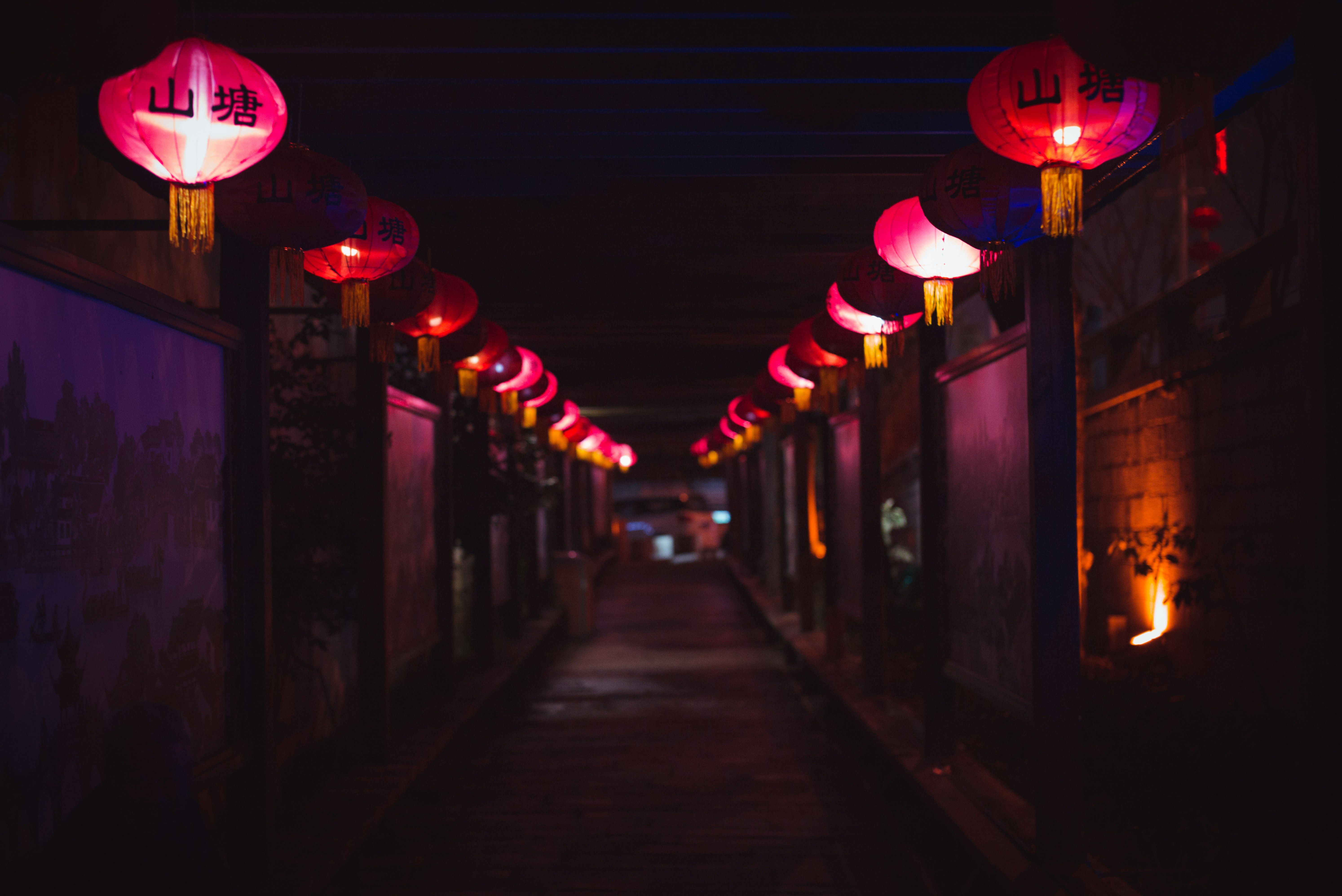 lighted paper lantern hanging on street